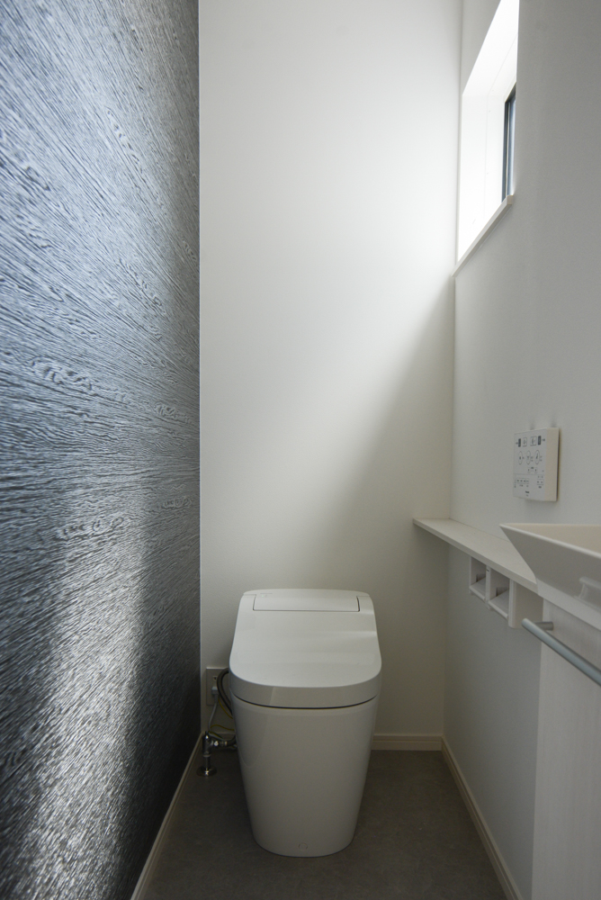 １階のトイレ（便器：Panasonic　アラウーノZ160/手洗いカウンター：Panasonic アラウーノ手洗い　ホワイトアッシュ/アクセントクロス：サンゲツ　FE-74473/クッションフロア：シンコール　E5080）